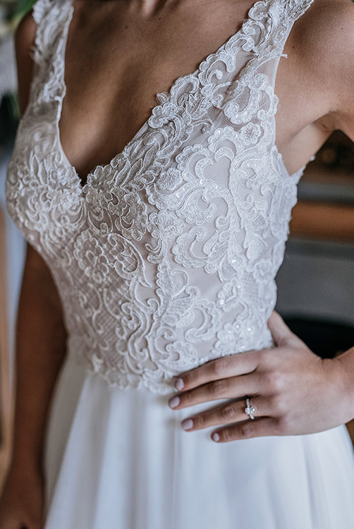 Close up of ivory lace on latte dress