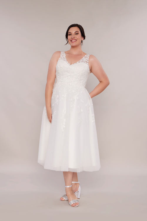 Three quarter length bridal gown. Bride wearing short gown.