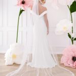 Back of crepe fitted wedding dress with lace trim veil