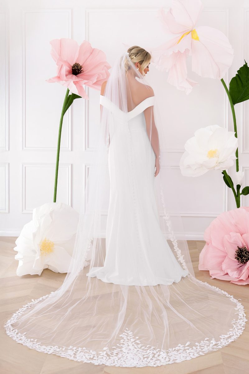 Back of crepe fitted wedding dress with lace trim veil