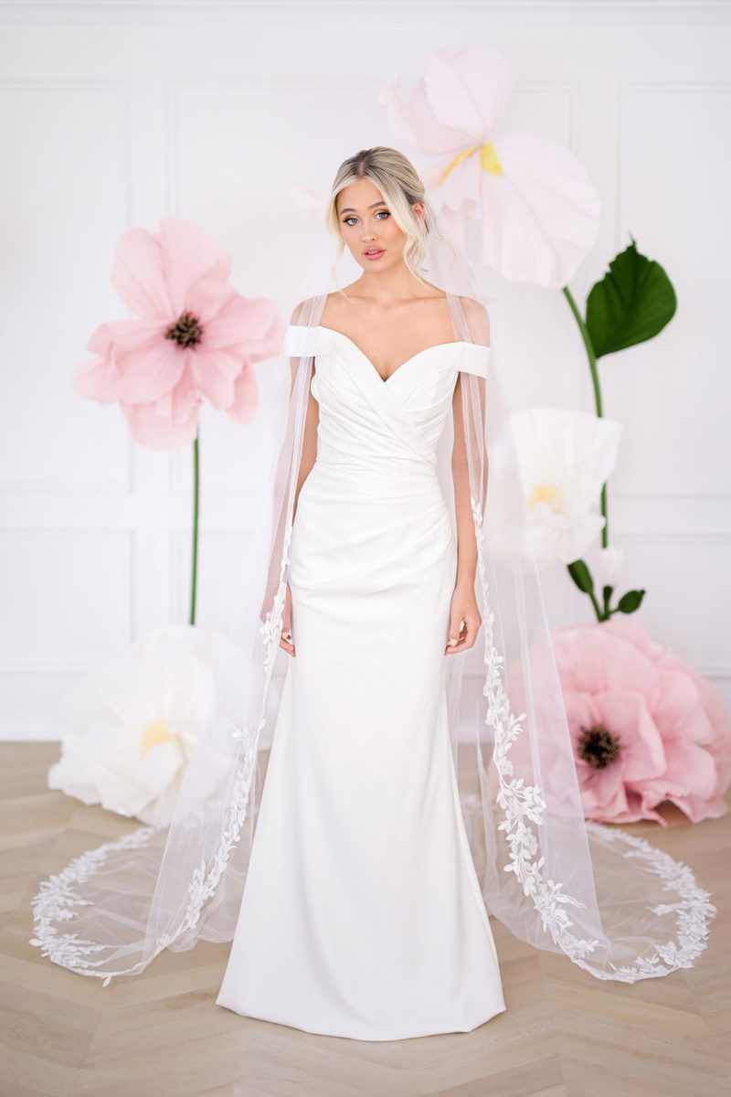 Misha ivory fitted crepe wedding dress with off shoulder neckline