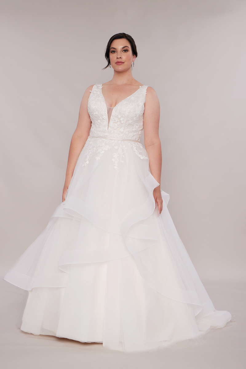 Phoebe plus size wedding dress with waterfall skirt.