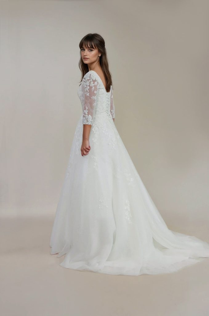 Back of Paloma wedding dress with lace sleeves and tulle train